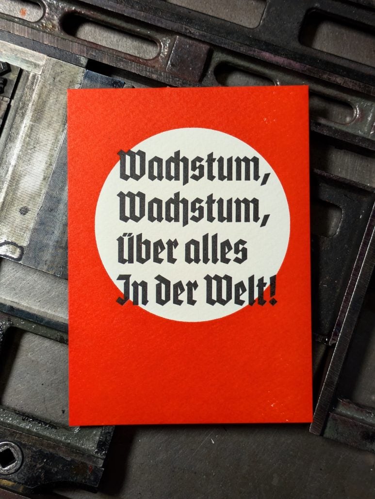 Motivationskarte mit dem Spruch 'Wachstum, Wachstum, Über alles in der Welt!'.